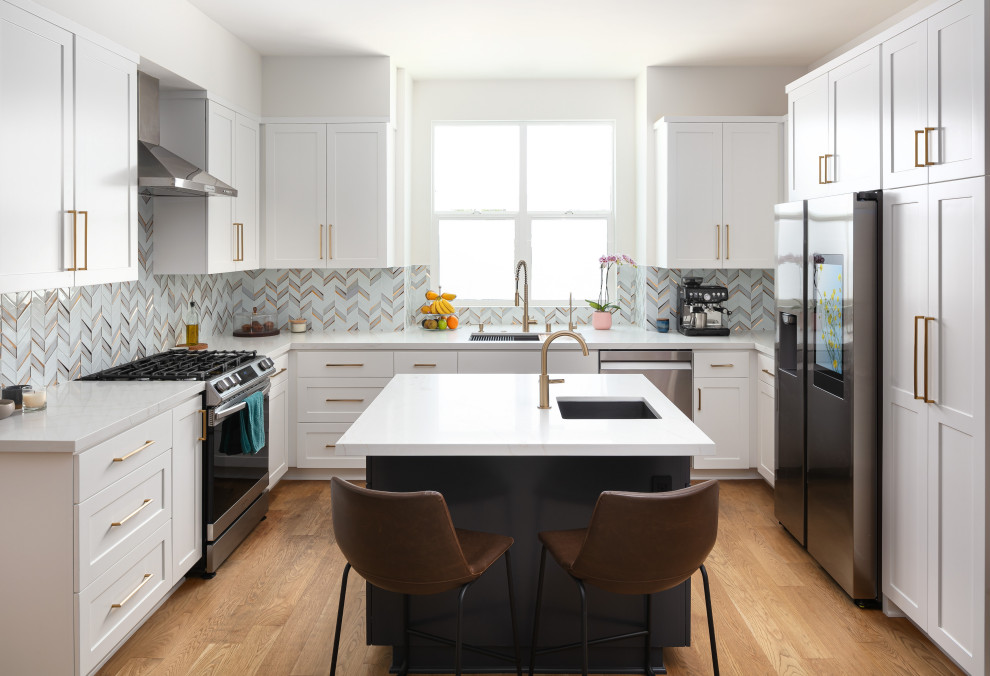 Inspiration for a mid-sized transitional u-shaped eat-in kitchen in Los Angeles with an undermount sink, shaker cabinets, white cabinets, quartz benchtops, grey splashback, marble splashback, stainless steel appliances, medium hardwood floors, with island, yellow floor and white benchtop.