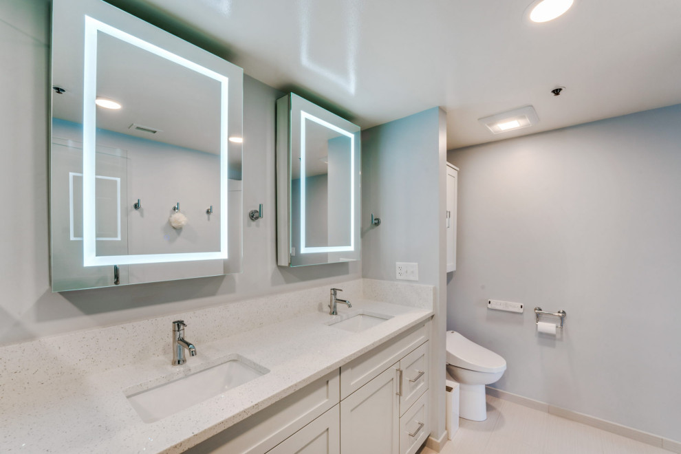 This is an example of a small contemporary master bathroom in Columbus with recessed-panel cabinets, white cabinets, a double shower, a bidet, white tile, white walls, porcelain floors, an undermount sink, engineered quartz benchtops, white floor, a hinged shower door, white benchtops, a shower seat, a double vanity, a built-in vanity and panelled walls.