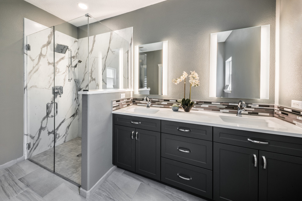 Photo of a mid-sized contemporary master bathroom in Boise with shaker cabinets, grey cabinets, a curbless shower, gray tile, metal tile, grey walls, porcelain floors, an undermount sink, engineered quartz benchtops, grey floor, a hinged shower door, white benchtops, a double vanity and a built-in vanity.