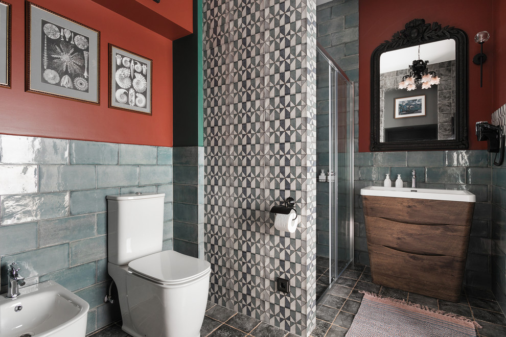 This is an example of a mid-sized mediterranean 3/4 bathroom in Saint Petersburg with ceramic tile, red walls, ceramic floors, grey floor, a sliding shower screen, flat-panel cabinets, dark wood cabinets, a two-piece toilet, blue tile, a corner shower and a console sink.