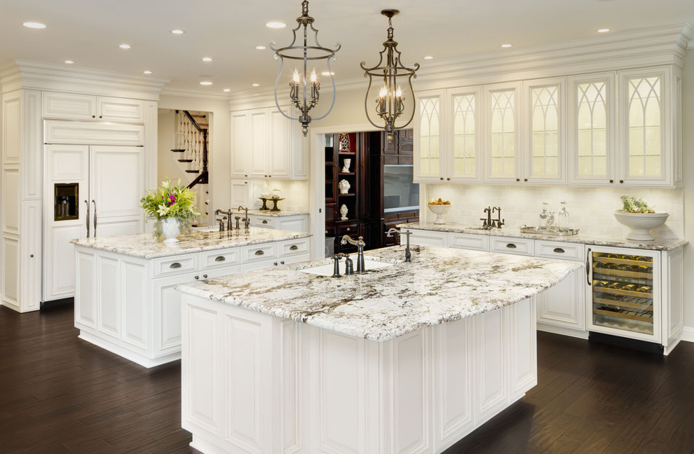 This is an example of a traditional kitchen in Chicago with glass-front cabinets, a single-bowl sink, white cabinets, granite benchtops and panelled appliances.