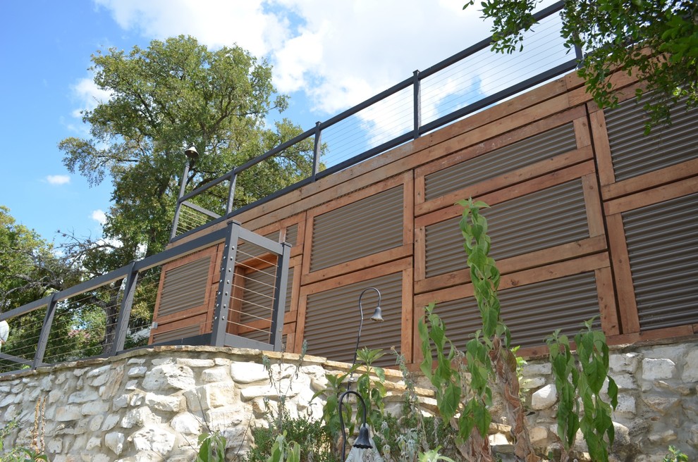 Photo of a mid-sized industrial beige exterior in Austin with mixed siding.