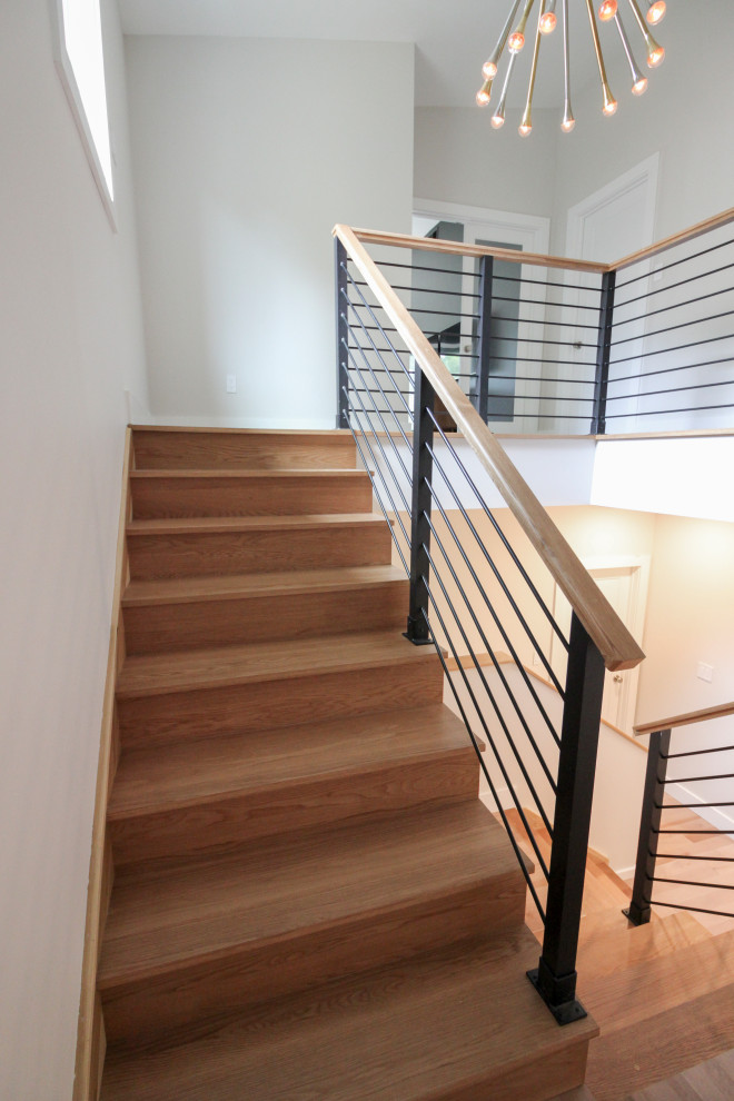 Design ideas for a large modern wood straight staircase in DC Metro with wood risers and mixed railing.