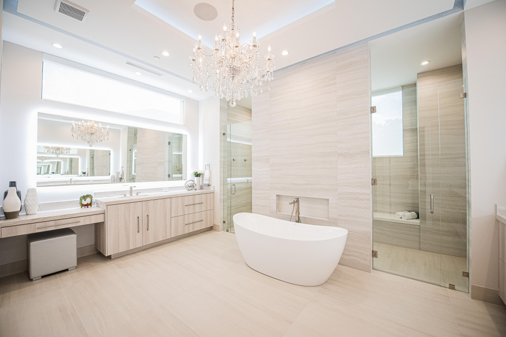 Inspiration for an expansive modern ensuite bathroom in Miami with flat-panel cabinets, light wood cabinets, a freestanding bath, a double shower, a bidet, white tiles, porcelain tiles, white walls, porcelain flooring, a submerged sink, quartz worktops, beige floors, a hinged door, white worktops, an enclosed toilet, double sinks, a built in vanity unit and a drop ceiling.