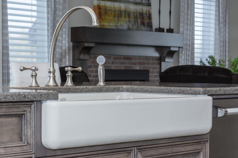 Inspiration for a large transitional porcelain tile kitchen remodel in Toronto with a farmhouse sink, white cabinets, quartz countertops, gray backsplash, ceramic backsplash, stainless steel appliances and an island