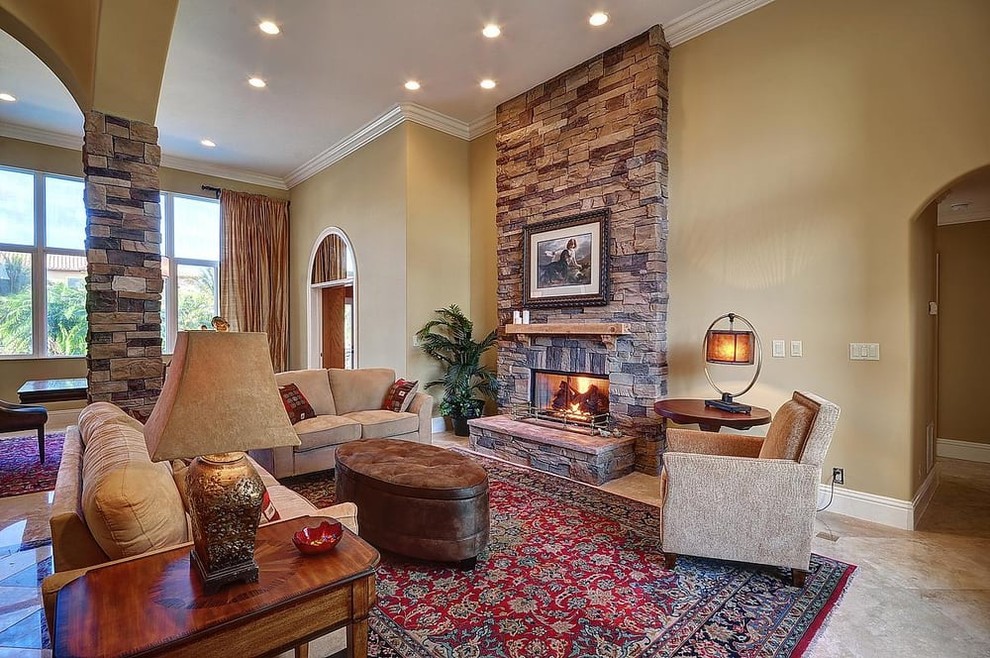 Design ideas for a mid-sized traditional formal open concept living room in Atlanta with beige walls, ceramic floors, a standard fireplace, a stone fireplace surround, no tv and brown floor.