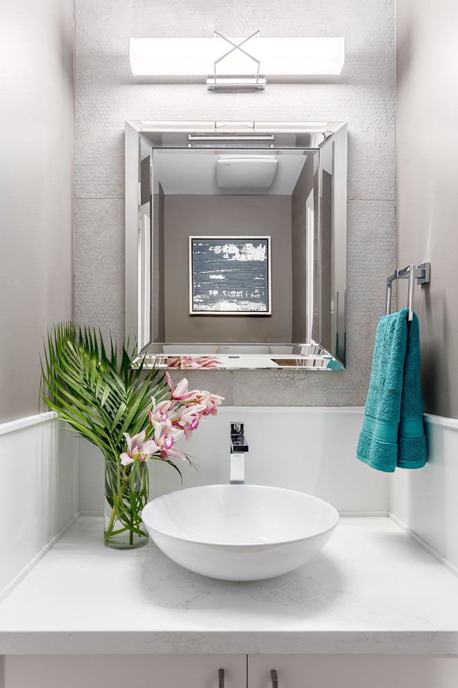 Small transitional powder room in Vancouver with flat-panel cabinets, white cabinets, a two-piece toilet, multi-coloured tile, porcelain tile, grey walls, medium hardwood floors, a vessel sink and quartzite benchtops.