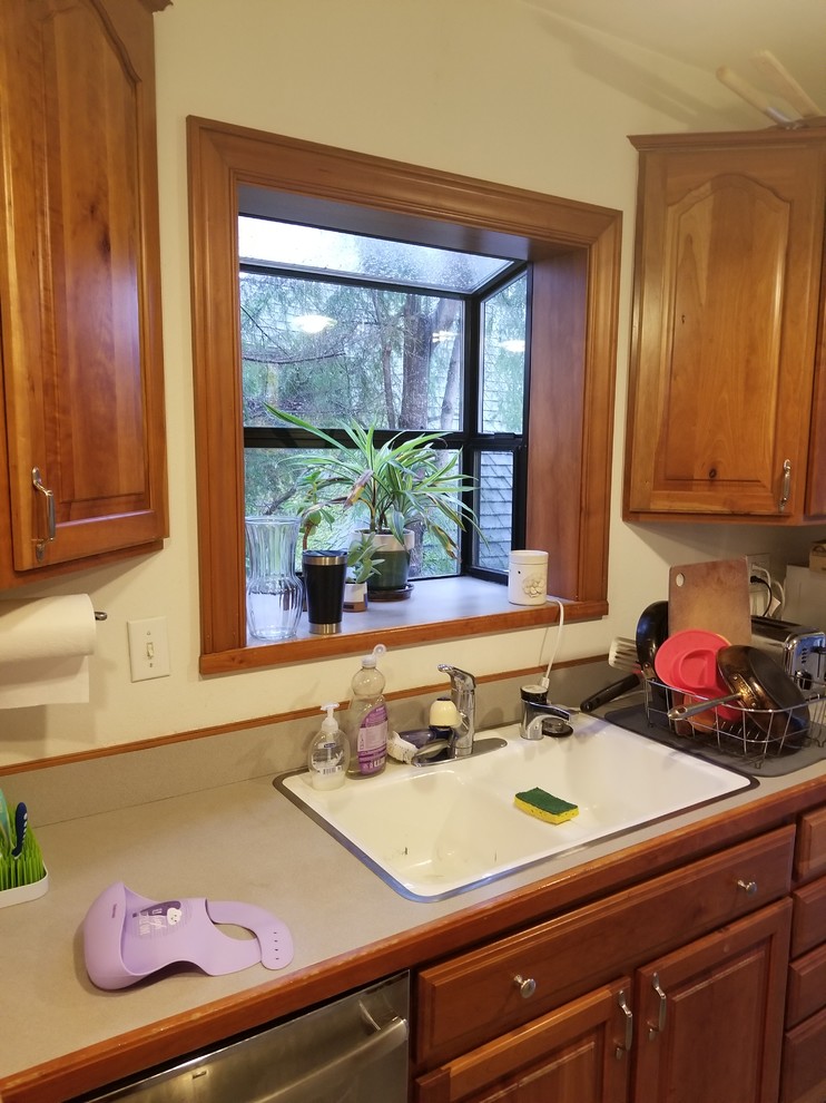 Inspiration for a mid-sized transitional galley ceramic tile and gray floor eat-in kitchen remodel in Seattle with an undermount sink, shaker cabinets, green cabinets, quartz countertops, white backsplash, brick backsplash, stainless steel appliances, no island and beige countertops