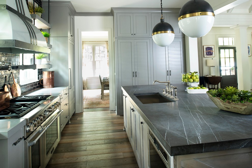 Example of a transitional kitchen design in Atlanta with marble countertops and an island