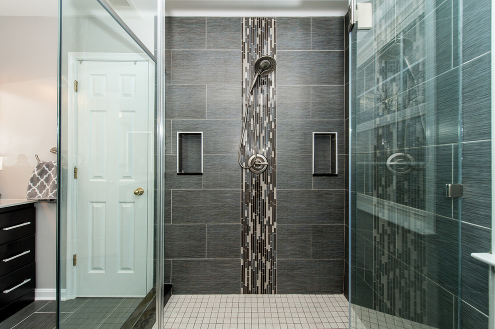 Inspiration for a large transitional master bathroom in Baltimore with flat-panel cabinets, dark wood cabinets, a corner shower, a two-piece toilet, gray tile, matchstick tile, grey walls, porcelain floors, an undermount sink, engineered quartz benchtops, grey floor and a hinged shower door.