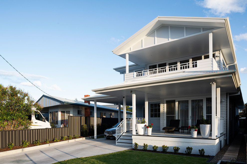 Example of a large beach style white two-story concrete fiberboard and board and batten exterior home design in Sydney with a metal roof and a white roof