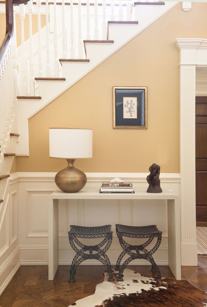 This is an example of a mid-sized transitional foyer in DC Metro with beige walls, medium hardwood floors and beige floor.