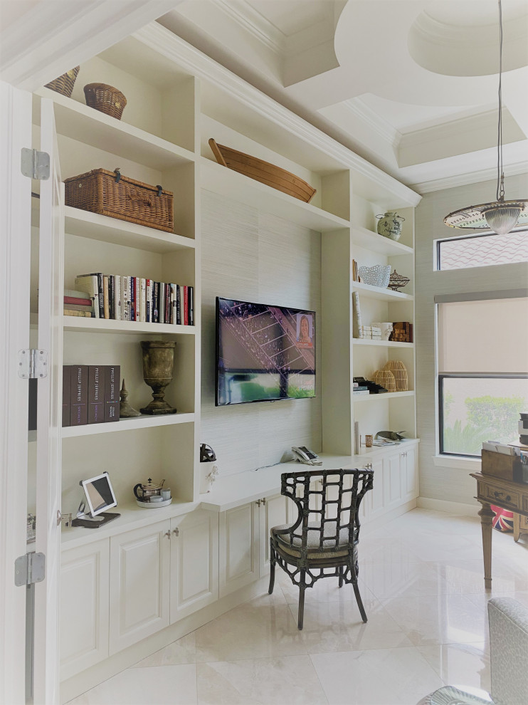 Photo of a midcentury home office in Miami with a library, marble floors, coffered and wallpaper.