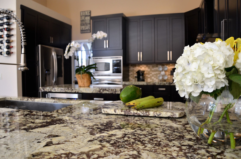 Example of a large transitional u-shaped porcelain tile open concept kitchen design in Miami with an undermount sink, shaker cabinets, dark wood cabinets, granite countertops, multicolored backsplash, mosaic tile backsplash, stainless steel appliances and an island