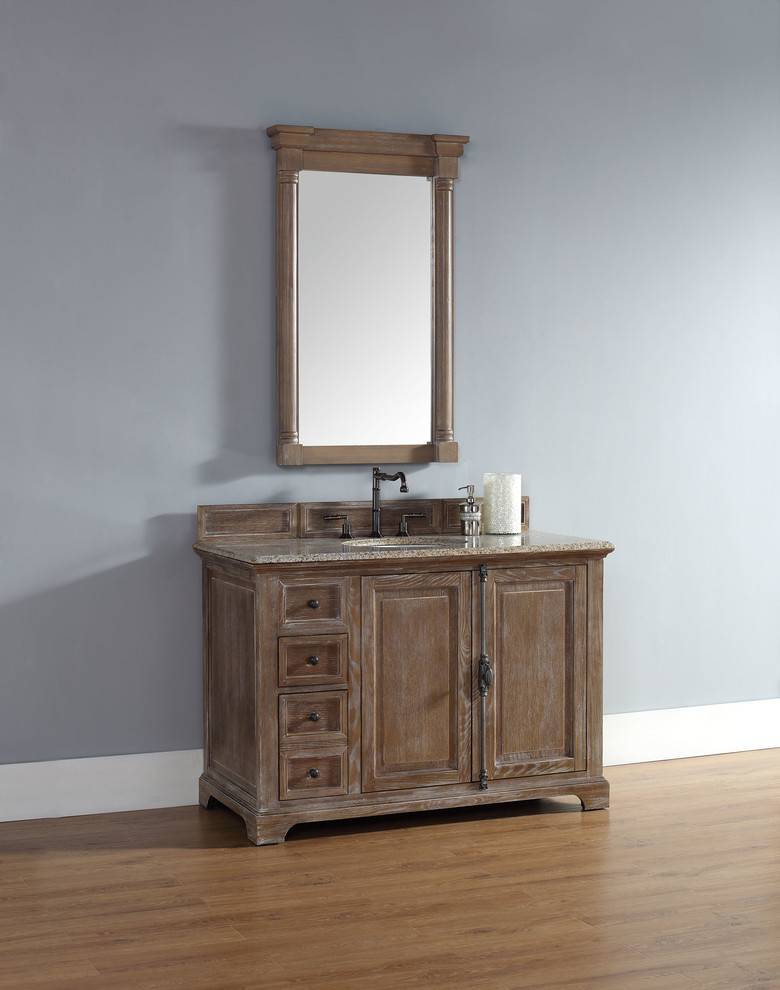 This is an example of a traditional bathroom in San Diego with furniture-like cabinets, medium wood cabinets, grey walls and light hardwood floors.