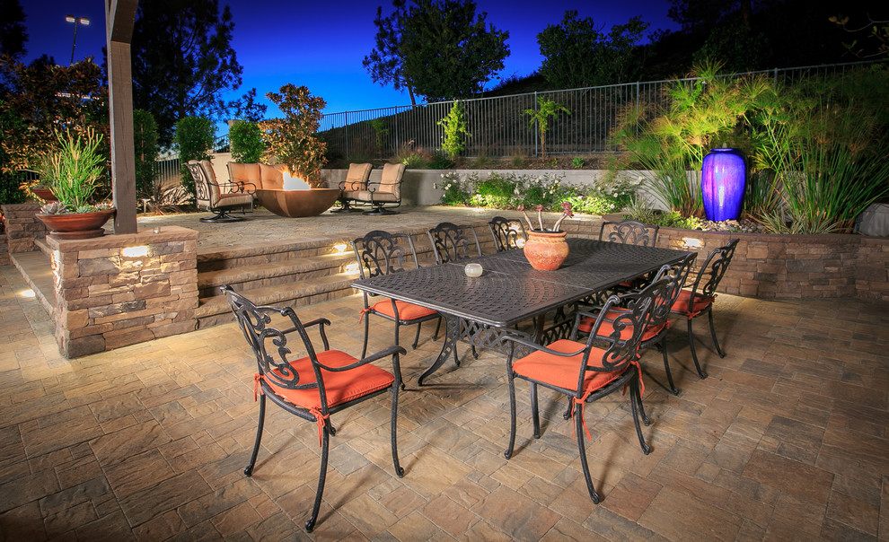 Design ideas for a large traditional backyard patio in San Diego with a fire feature, concrete pavers and a pergola.