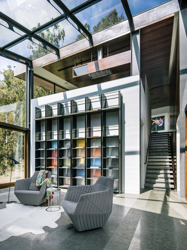 Example of a mid-sized trendy concrete floor and gray floor living room design in San Francisco with white walls