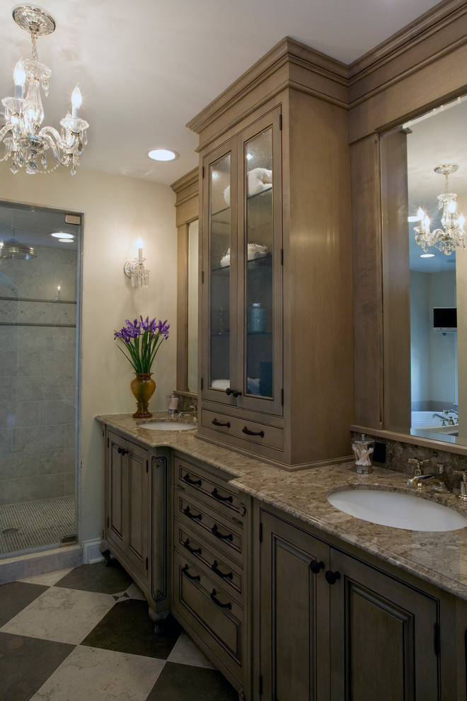 Large traditional master bathroom in Chicago with raised-panel cabinets, medium wood cabinets, an alcove shower, multi-coloured tile, stone tile, beige walls, limestone floors, an undermount sink and granite benchtops.