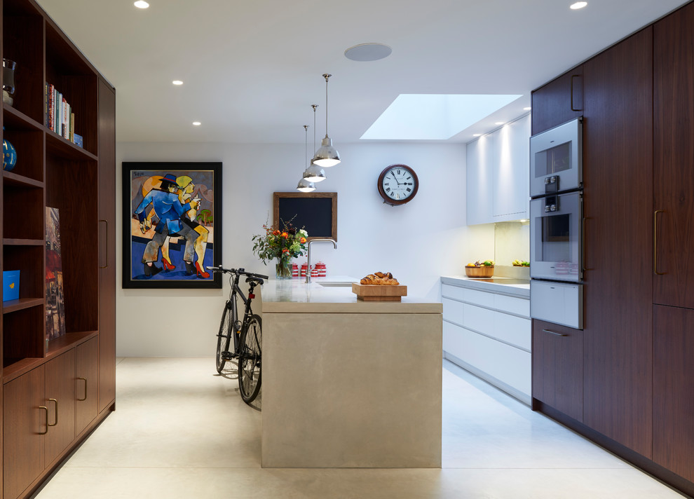 Inspiration for a mid-sized contemporary galley kitchen in London with an undermount sink, flat-panel cabinets, dark wood cabinets, panelled appliances, concrete floors, a peninsula, grey floor and beige benchtop.