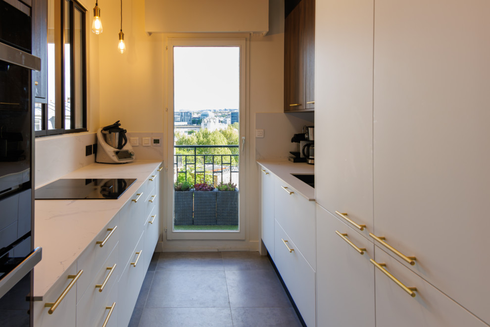 Modern galley separate kitchen in Paris with grey floor.