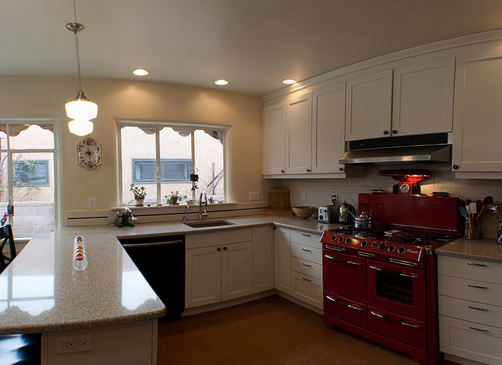 Small transitional u-shaped eat-in kitchen photo in Orange County with an undermount sink, shaker cabinets, white cabinets, granite countertops, white backsplash, subway tile backsplash, colored appliances and a peninsula