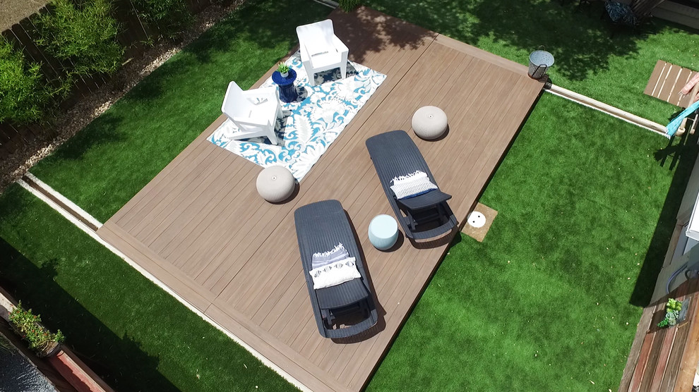 Pool - small modern backyard rectangular pool idea in Austin with decking