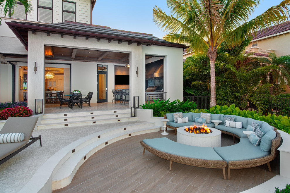 Photo of a mediterranean backyard patio in Miami with a fire feature and no cover.