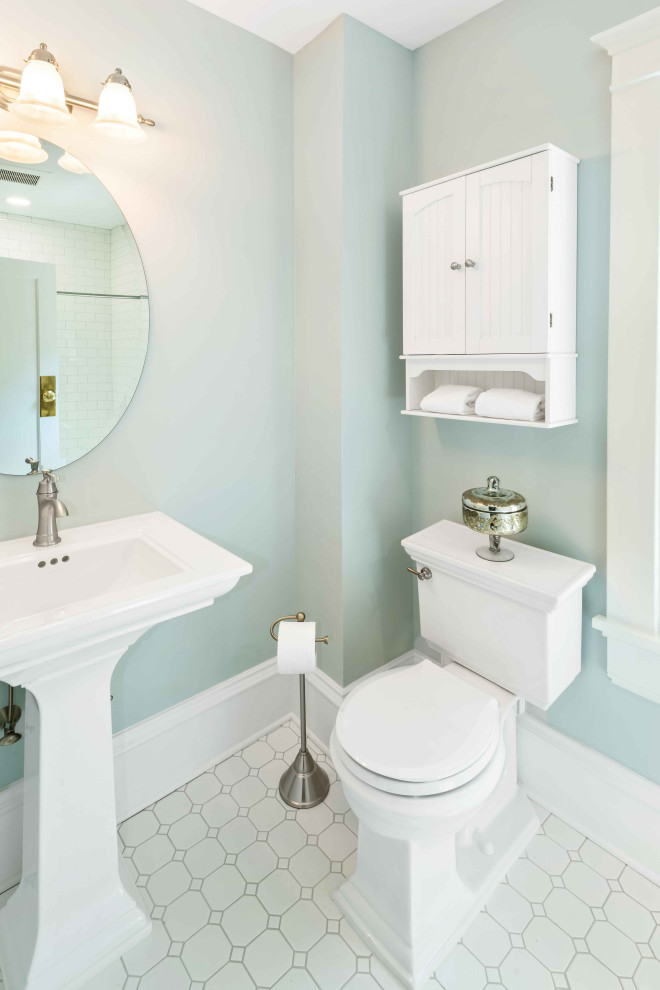 This is an example of a small traditional bathroom in Raleigh with an alcove tub, a two-piece toilet, white tile, porcelain tile, green walls, porcelain floors, a pedestal sink and white floor.