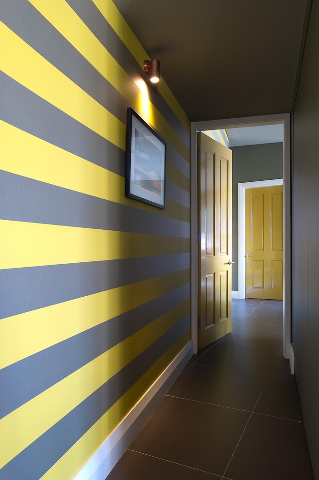 This is an example of a mid-sized industrial hallway in Sydney with multi-coloured walls, porcelain floors and grey floor.