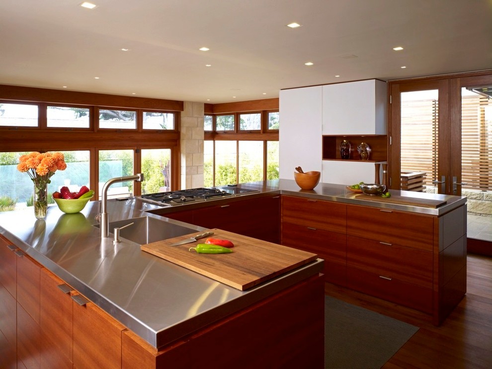 Design ideas for a mid-sized midcentury u-shaped open plan kitchen in San Francisco with flat-panel cabinets, dark wood cabinets, stainless steel benchtops, dark hardwood floors, a peninsula and brown floor.