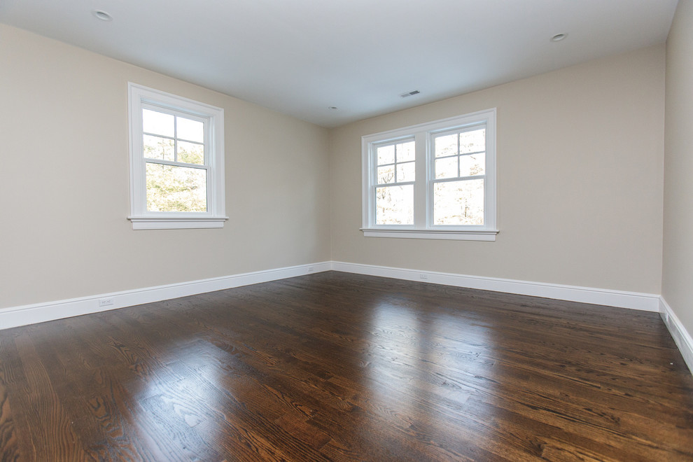 Design ideas for a large traditional master bedroom in Boston with beige walls and dark hardwood floors.