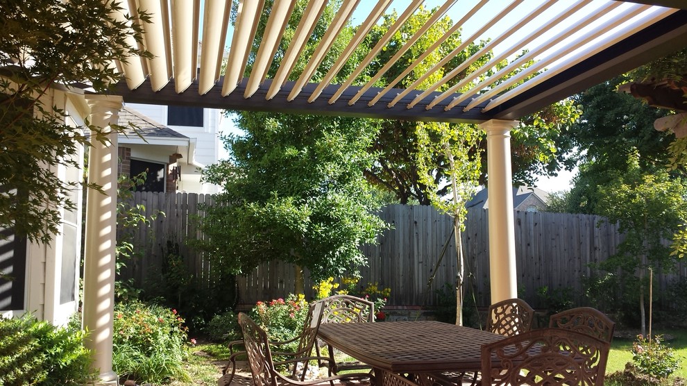 Photo of a mid-sized traditional backyard patio in Dallas with a pergola.