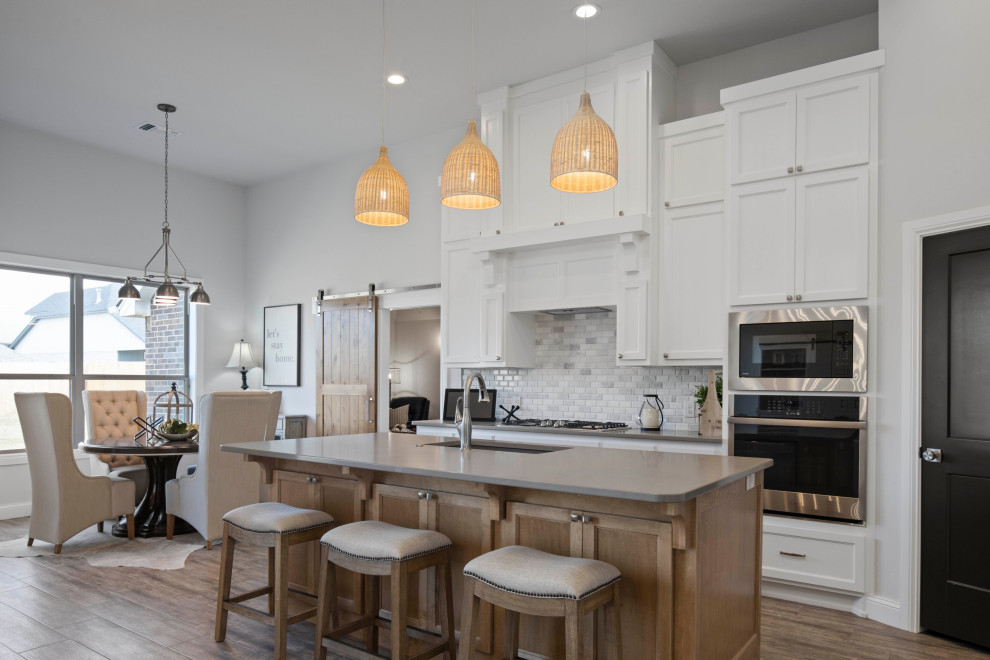 Design ideas for a country eat-in kitchen in Oklahoma City with shaker cabinets, white cabinets, quartzite benchtops, stainless steel appliances, with island and grey benchtop.