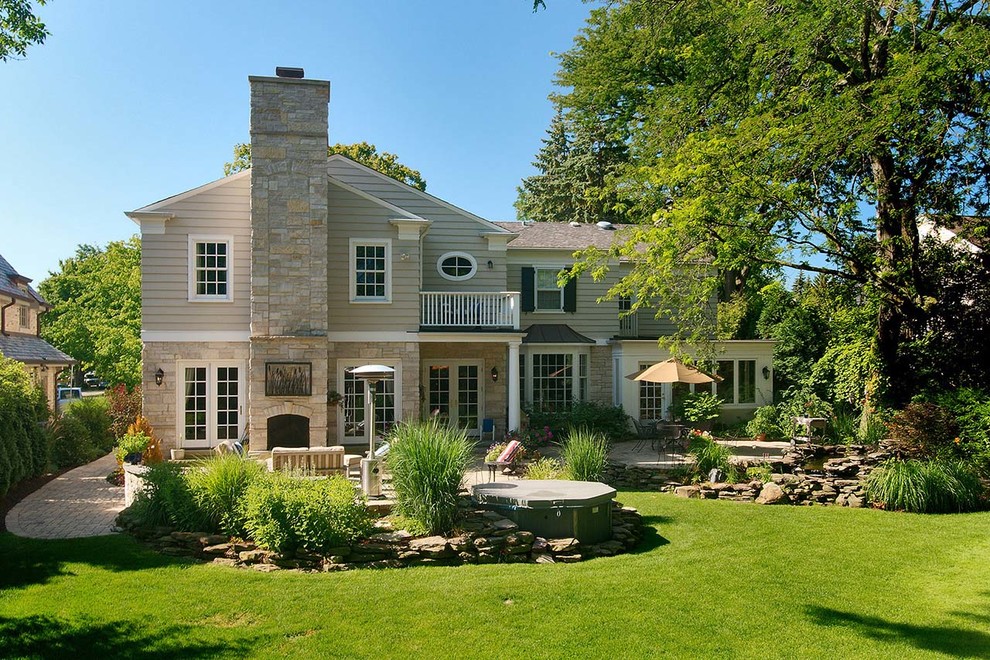Design ideas for a large transitional backyard brick formal garden in Chicago with a fire pit for summer.