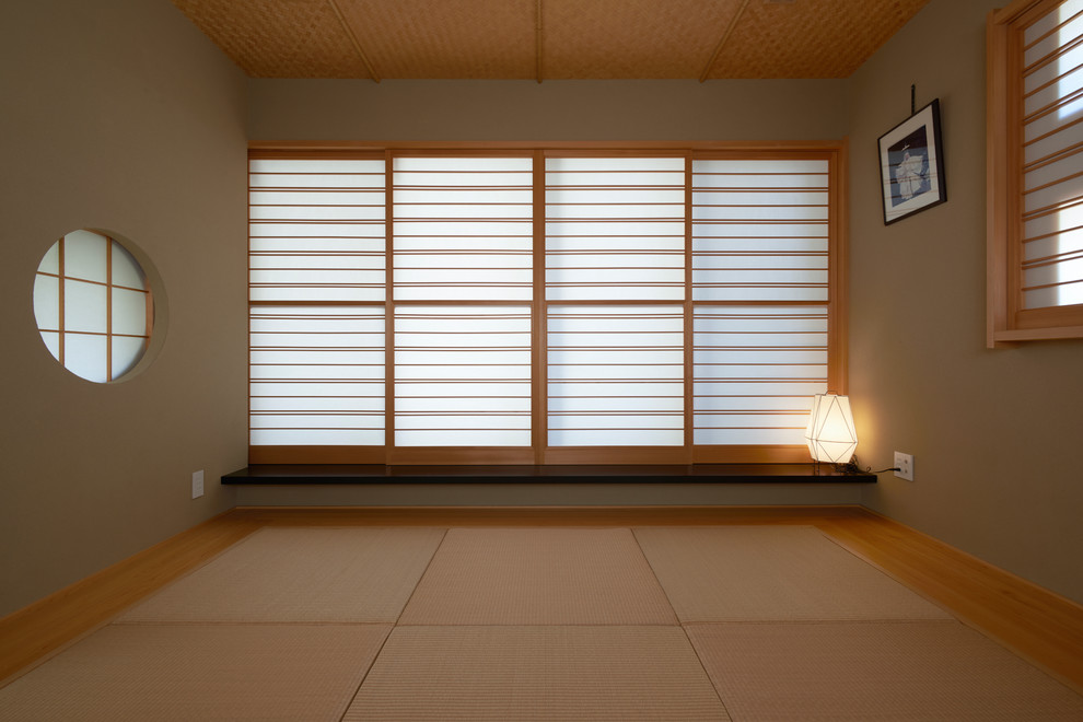This is an example of an asian family room in Tokyo with grey walls, tatami floors, no fireplace and no tv.