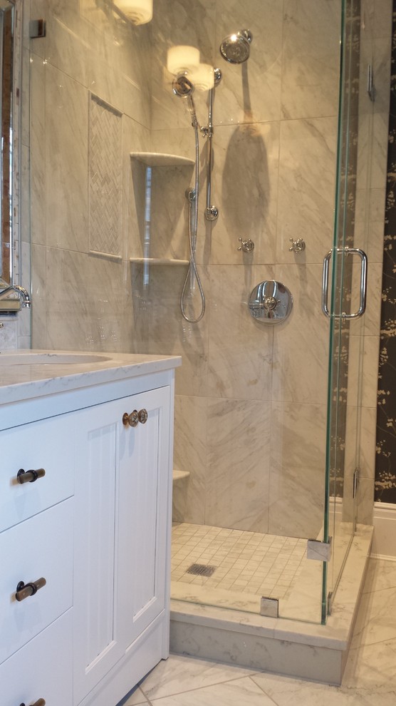 This is an example of a victorian bathroom in New York with beaded cabinets, white cabinets, a freestanding bath, grey tiles, ceramic flooring and a submerged sink.
