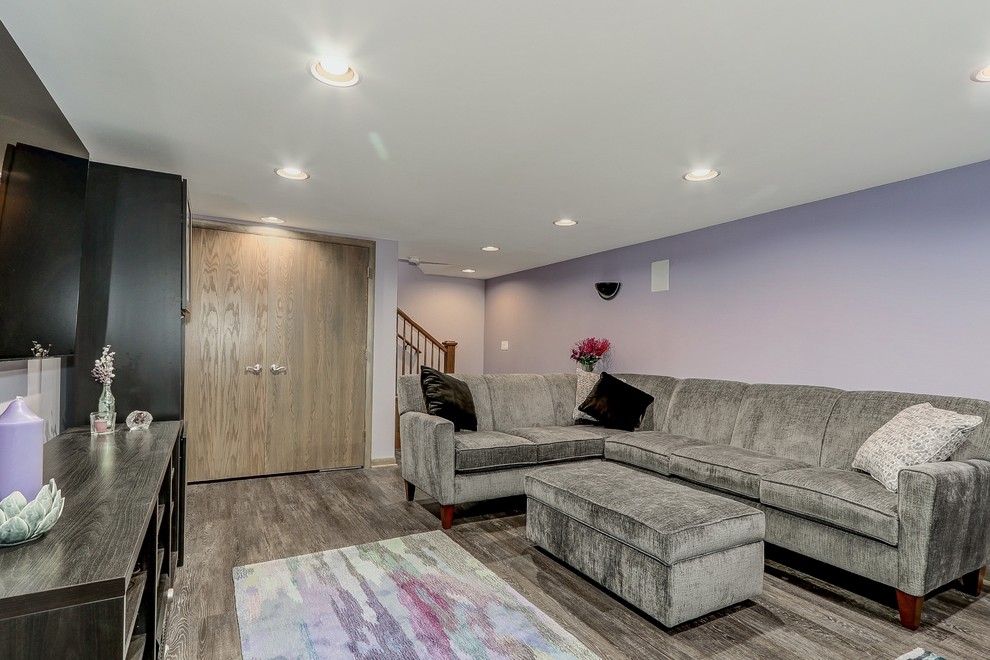 Inspiration for a small transitional fully buried basement in Chicago with purple walls, vinyl floors, no fireplace and brown floor.