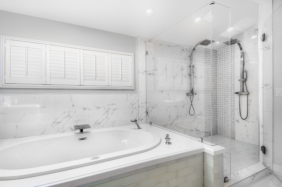 Large transitional master bathroom in San Francisco with recessed-panel cabinets, a double shower, a one-piece toilet, white tile, gray tile, grey walls, ceramic floors, an undermount sink, engineered quartz benchtops, black cabinets, a drop-in tub and stone slab.
