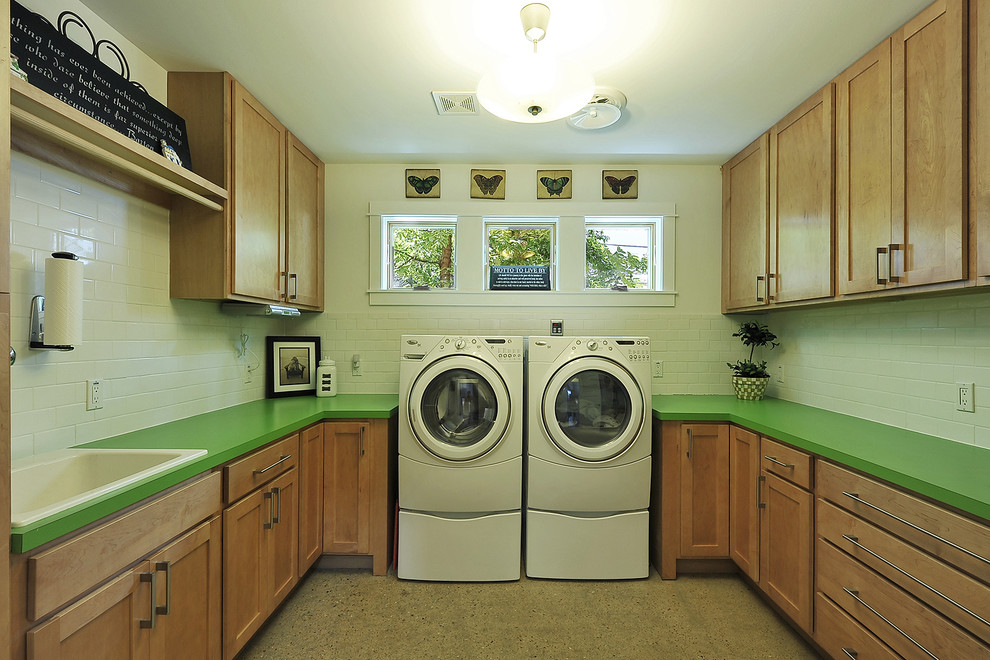 Photo of a transitional laundry room in Austin with a drop-in sink and green benchtop.