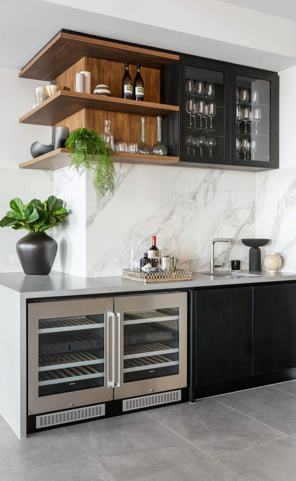 Inspiration for a contemporary l-shaped wet bar in Chicago with a submerged sink, flat-panel cabinets, black cabinets, concrete worktops, multi-coloured splashback, engineered quartz splashback, concrete flooring, grey floors and grey worktops.
