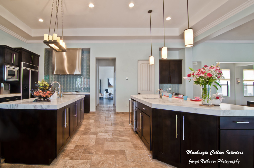 Large transitional u-shaped travertine floor eat-in kitchen photo in Phoenix with an undermount sink, shaker cabinets, dark wood cabinets, blue backsplash, subway tile backsplash, stainless steel appliances, two islands and marble countertops