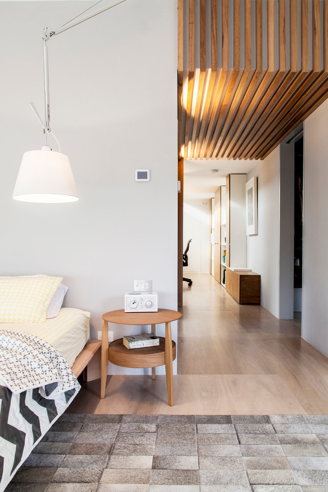 Design ideas for a contemporary master bedroom in Melbourne with grey walls and plywood floors.