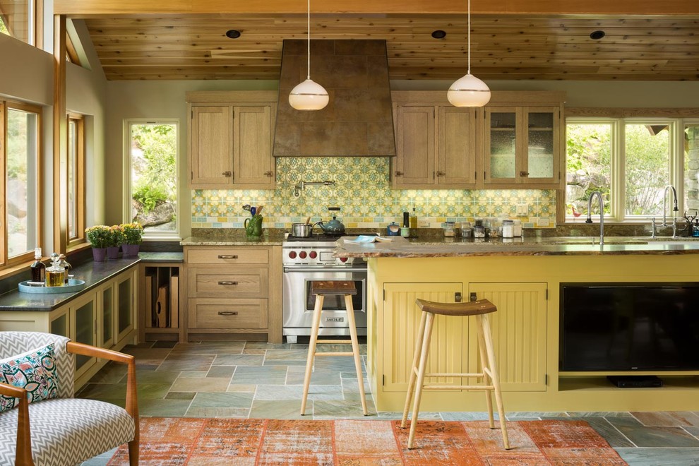 Photo of a country kitchen in Portland Maine with with island, shaker cabinets, light wood cabinets, multi-coloured splashback, stainless steel appliances and multi-coloured floor.