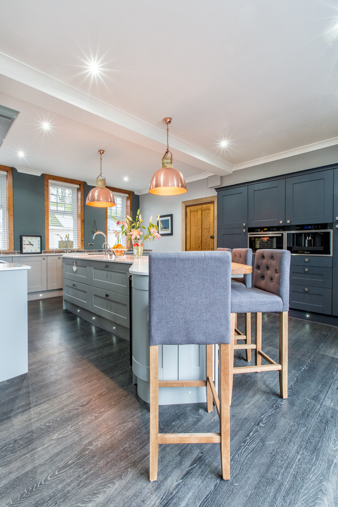 Photo of a large contemporary l-shaped eat-in kitchen in Other with a drop-in sink, grey cabinets and with island.