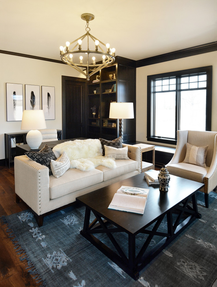 Large transitional home office in Milwaukee with a library, white walls, dark hardwood floors, a standard fireplace, a stone fireplace surround, a freestanding desk and brown floor.