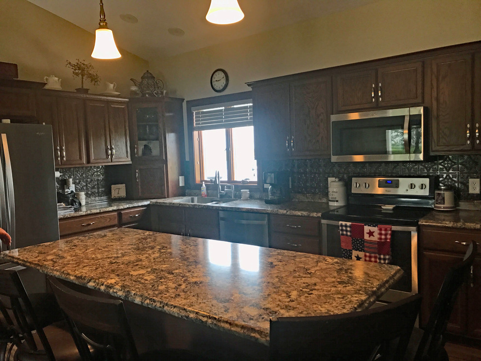 Example of a brown floor kitchen design with brown cabinets, brown backsplash, an island and brown countertops