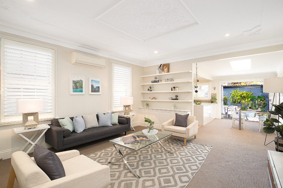 Photo of a mid-sized beach style formal open concept living room in Sydney with beige walls, carpet, no fireplace, no tv and beige floor.