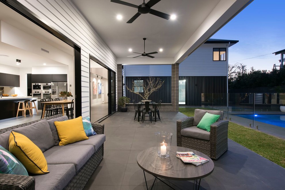 Design ideas for a contemporary backyard patio in Brisbane with a roof extension.