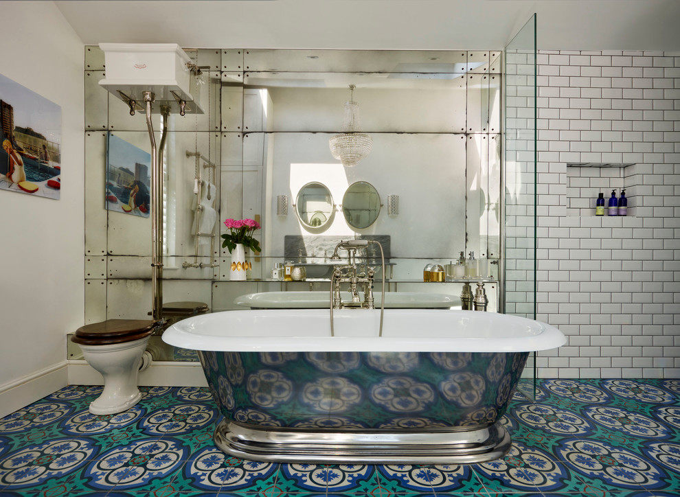 This is an example of a large traditional master bathroom in London with an undermount sink, a freestanding tub, an alcove shower, a one-piece toilet, multi-coloured tile, cement tile, white walls and mosaic tile floors.