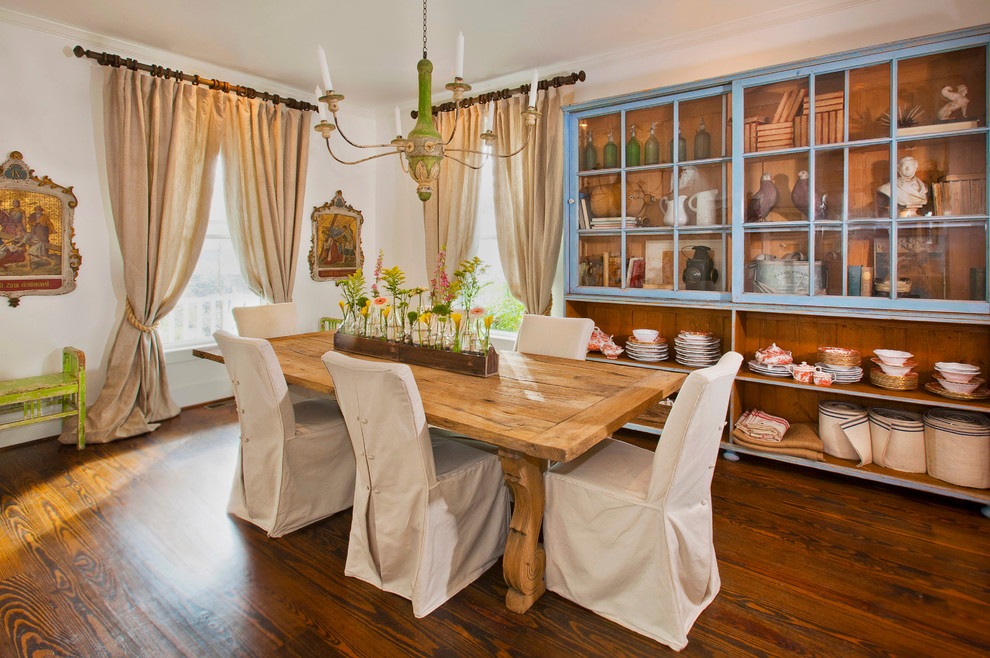 Country dining room in Little Rock with dark hardwood floors and no fireplace.